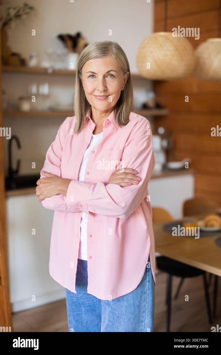 Elderly lady posing casually indoors with relaxed expression Stock Photo