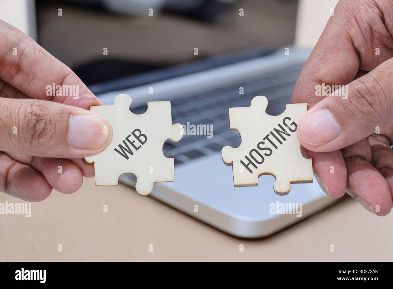 Hands holding two puzzle pieces labeled web and hosting. Website development, web hosting services, technology solutions concept. Stock Photo