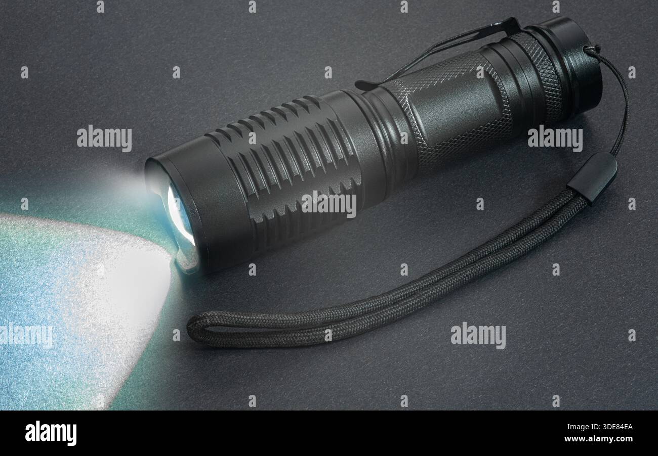 hand flashlight close-up, on a black background Stock Photo
