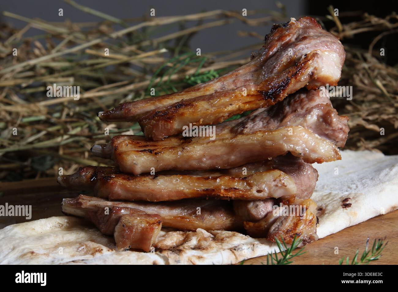 A hearty, close-up shot of a stack of gourmet grilled lamb chops 