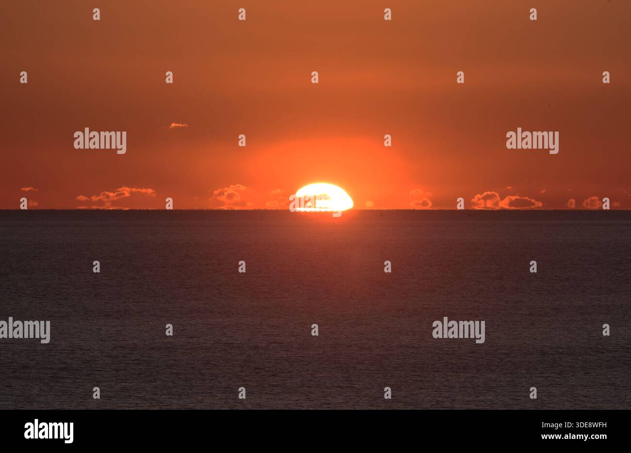 Sunset over the sea taken from the beach at Shoreham by Sea West Sussex Stock Photo