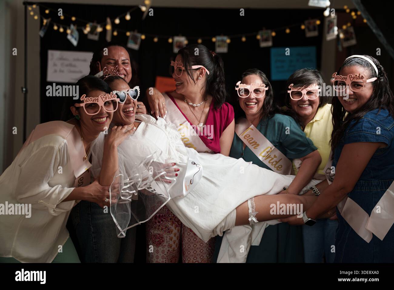 A group of women are posing for a picture, one of them is wearing a ...