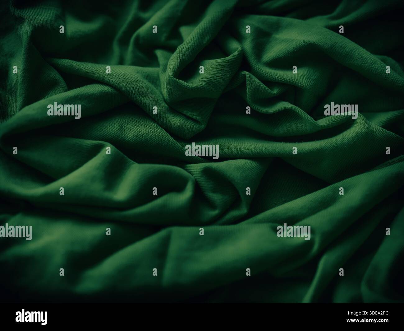 A crumpled green fabric background. Close up. Stock Photo