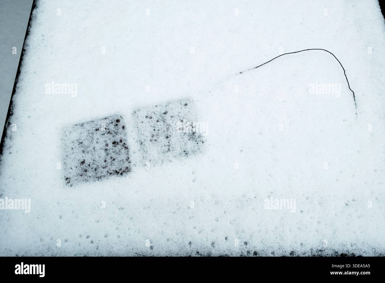 Abstract patterns in the snow on garden furniture Stock Photo
