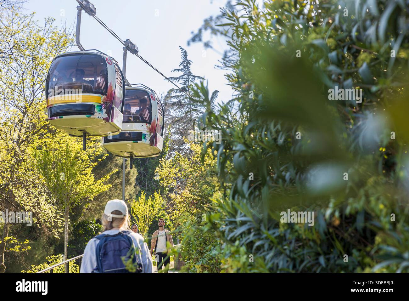 Istanbul, Turkey, 5 May 2025, TF1 Macka-Taskisla Aerial Cable Car Line cabins Two gondola cable cars  line passing above a walkway in a park, Stock Photo
