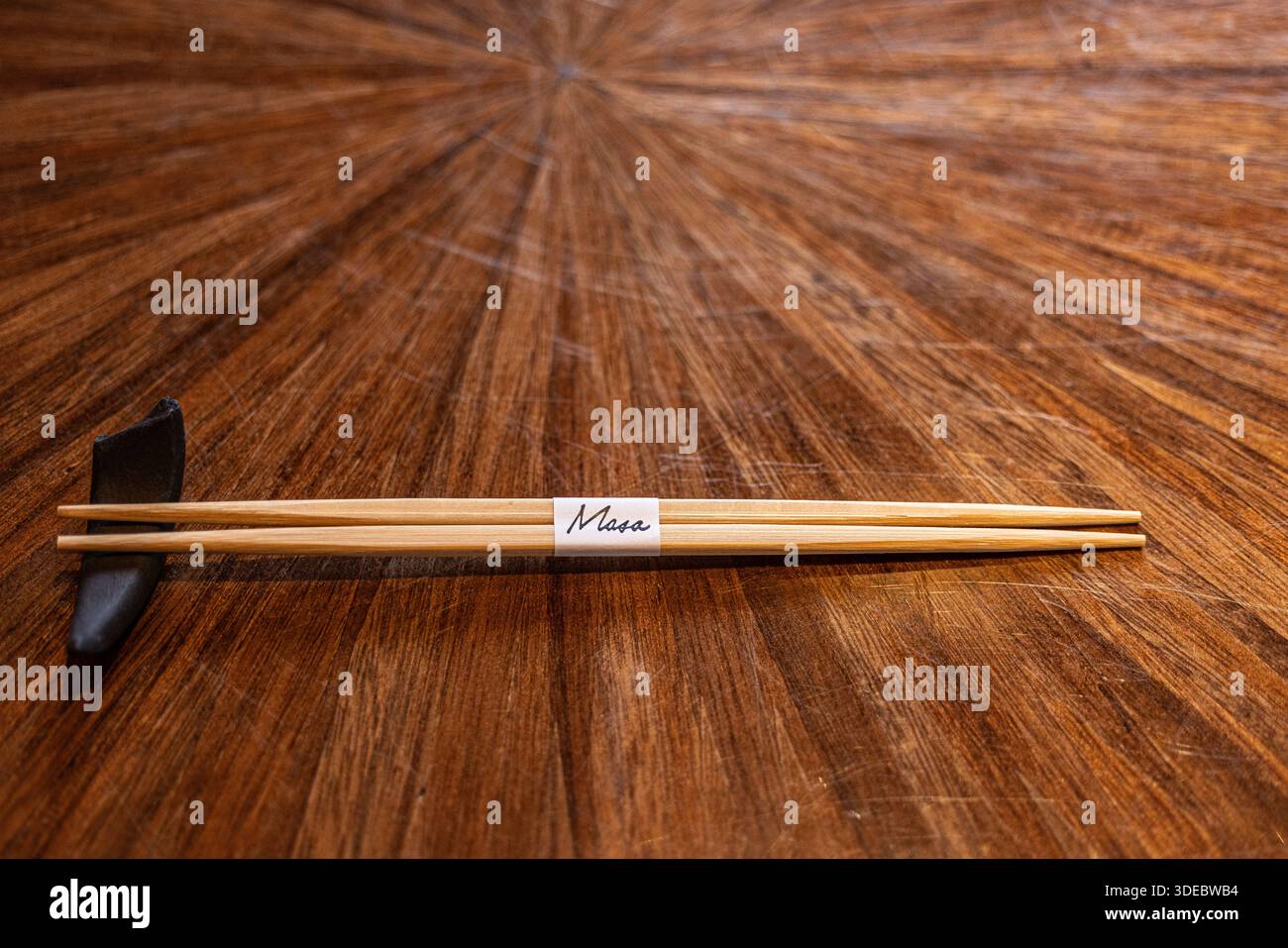 Tobi Masa, a high-end Japanese restaurant in London, featuring chopsticks (hashi) resting on a ceramic hashioki chopstick rest. Stock Photo