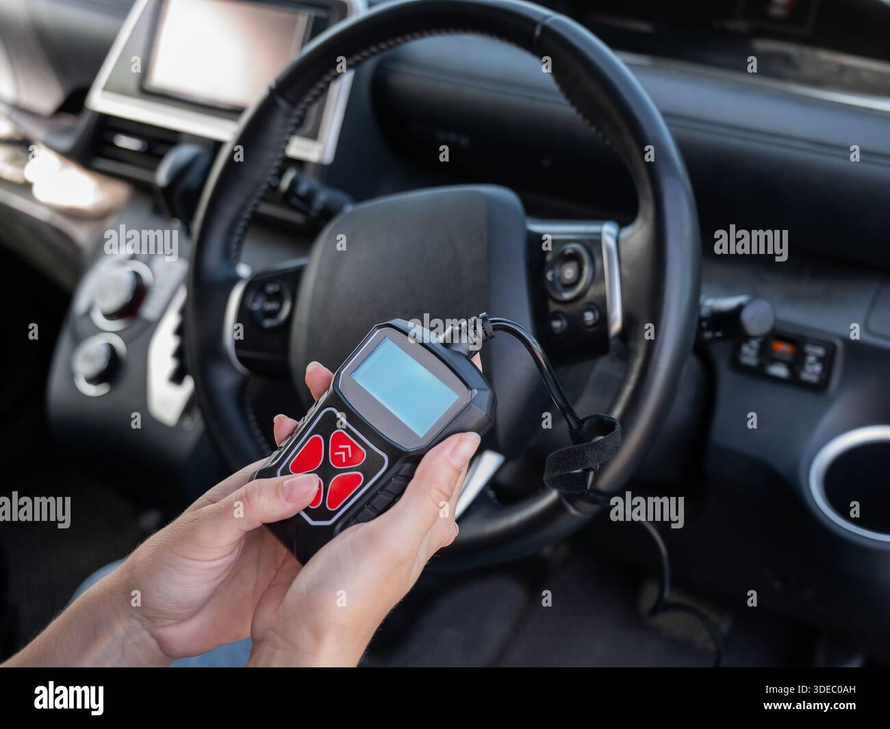 Woman using OBD2 diagnostic scanner.  Stock Photo