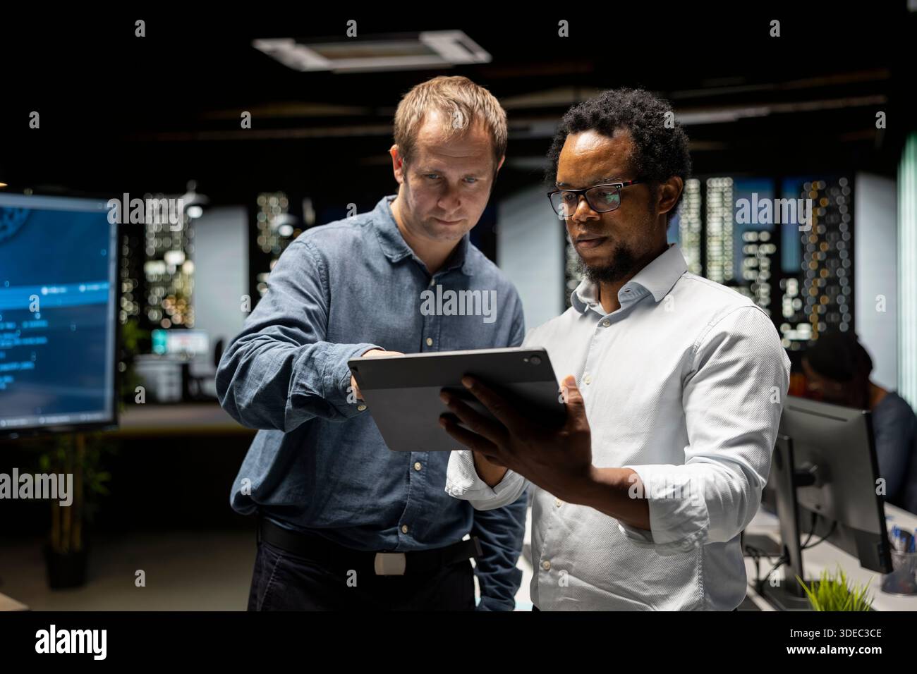 Team of programmers in office doing brainstorming, automating repetitive tasks using AI scripts on devices. Colleagues work together using artificial intelligence to speed up feature implementation Stock Photo