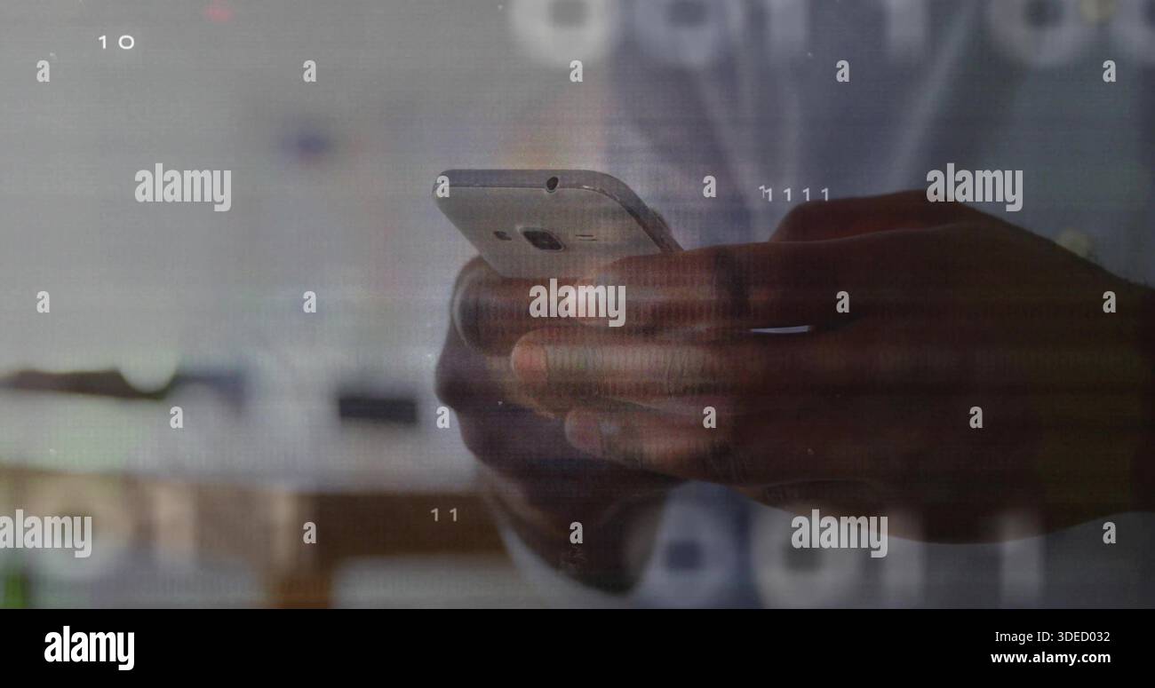 Holding dark-skinned male hands typing on smartphone at workspace, with digital overlays visible Stock Photo