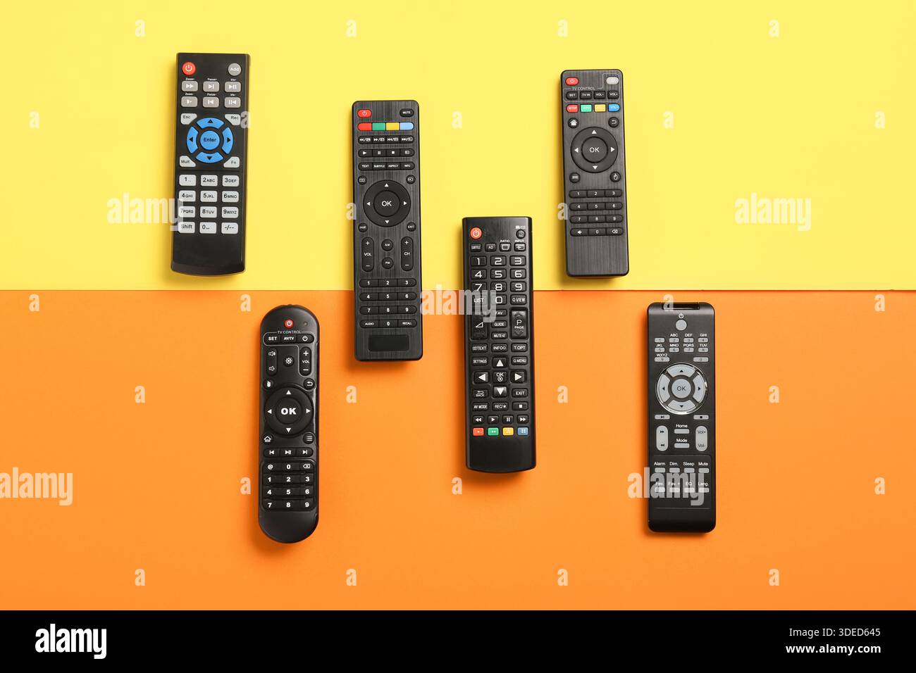 Different modern TV remote controls on color background Stock Photo