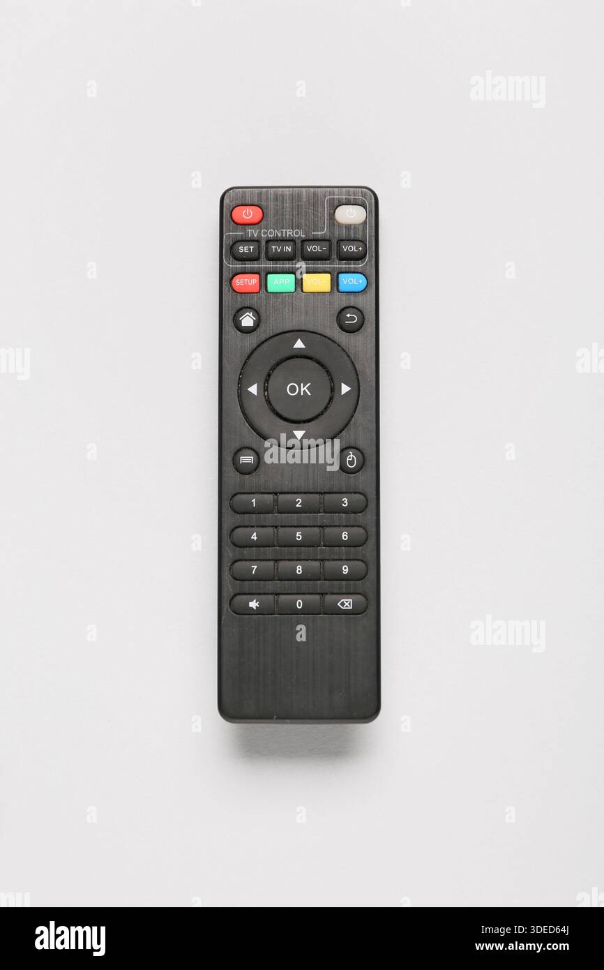 Modern TV remote controls on grey background Stock Photo