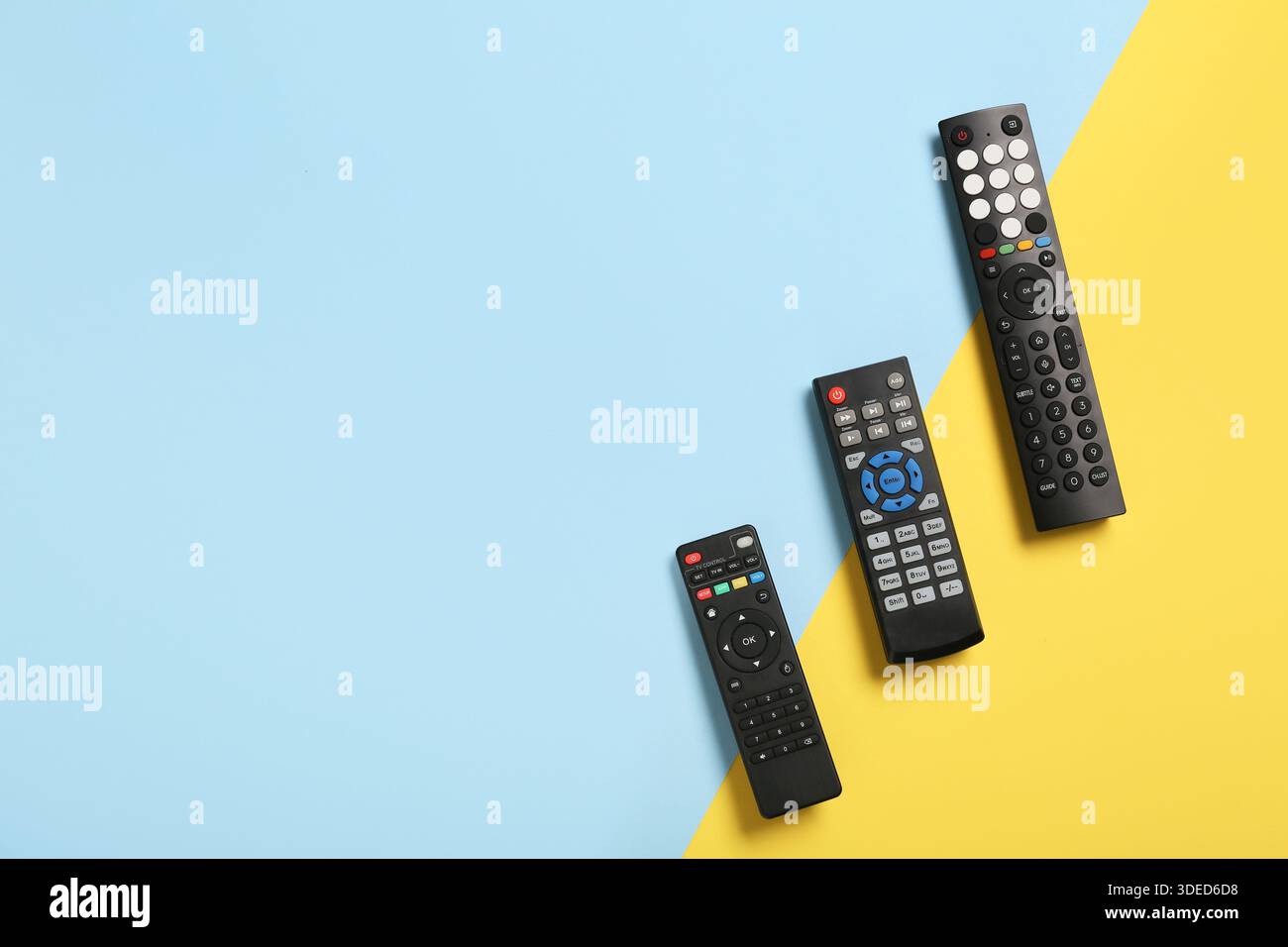 Different modern TV remote controls on color background Stock Photo