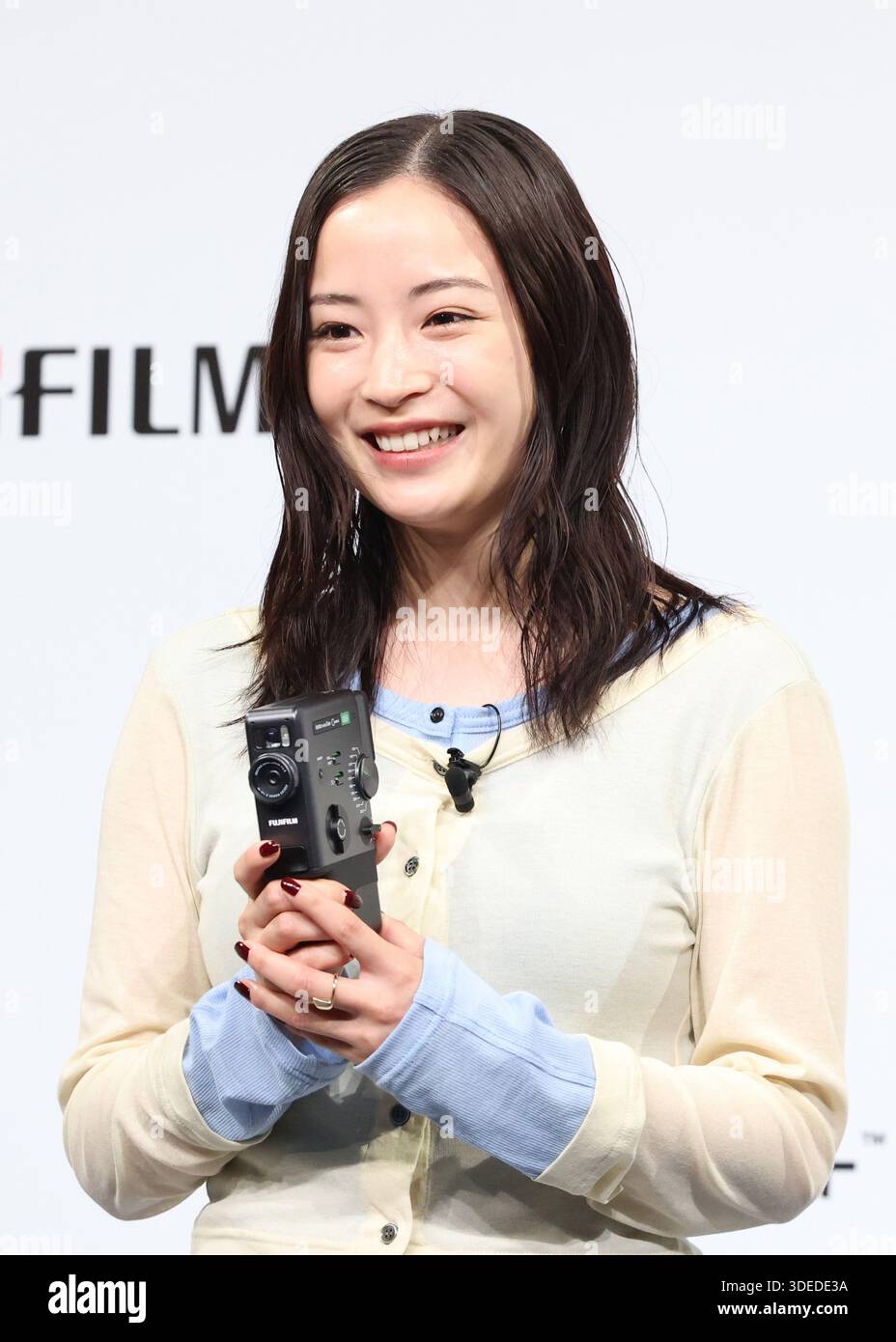 Tokyo, Japan. 7th Jan, 2026. Japanese actress Suzu Hirose attends a promotional event of Fujifilm's hybrid instant camera 'instax mini Evo Cinema' which will go on sale from January 30 in Tokyo on Wednesday, January 7, 2025. The new 'instax mini Evo Cinema' can take instant pictures and also take maximum 15-second short movies with retro 8mm movie camera style body. Users can play captured movies with QR code printed on the instant picture. (photo by Yoshio Tsunoda/AFLO) Stock Photo