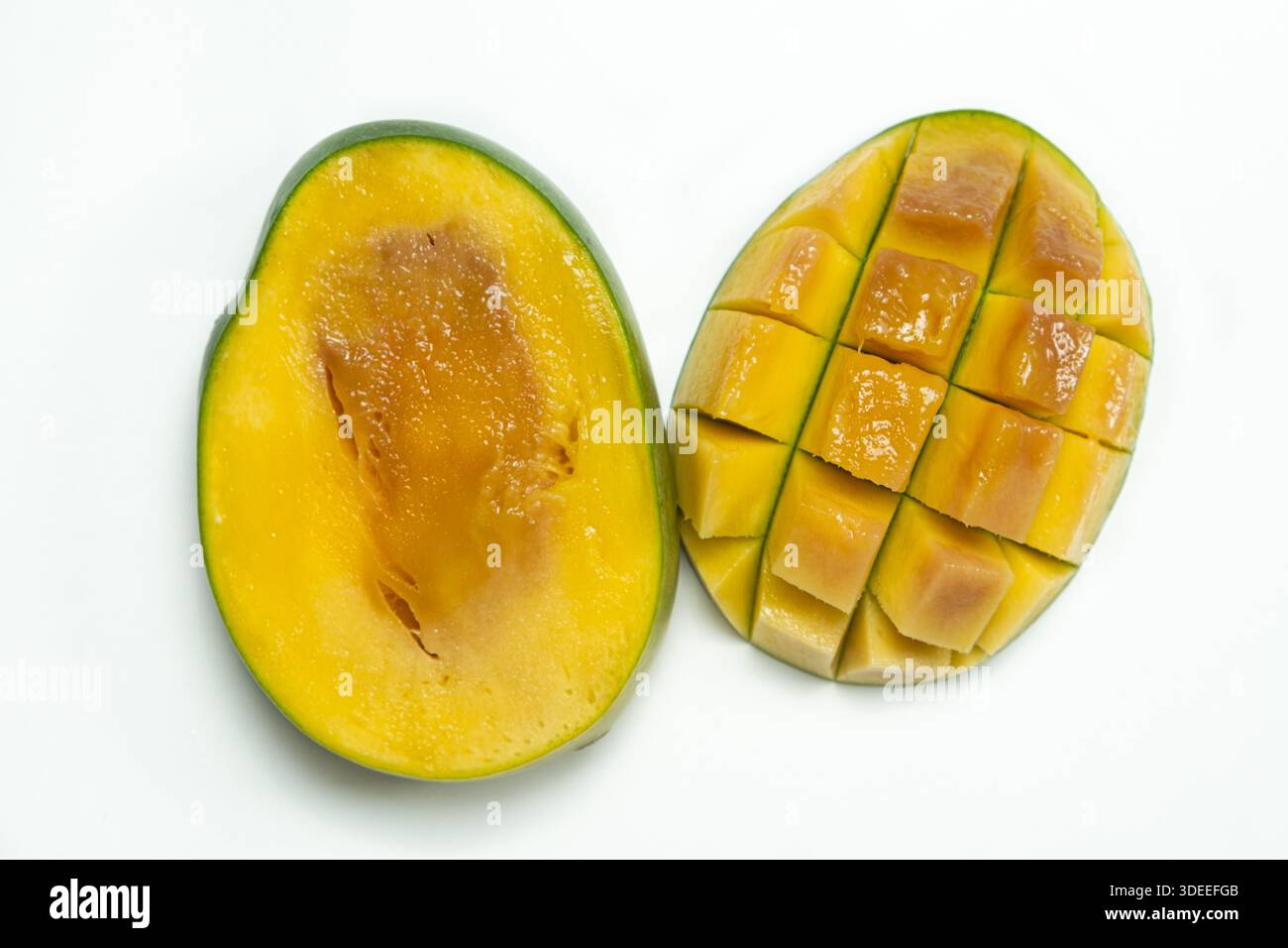 Inside of a very ripe mango sliced in half on white background Stock ...