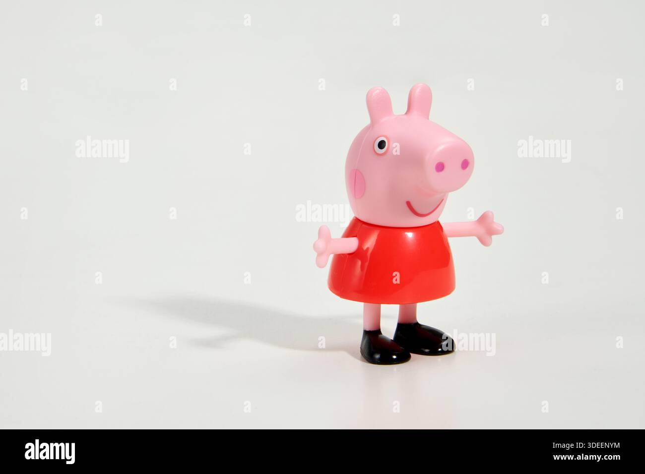 Cute toy figure of famous cartoon character Peppa Pig on white background Stock Photo
