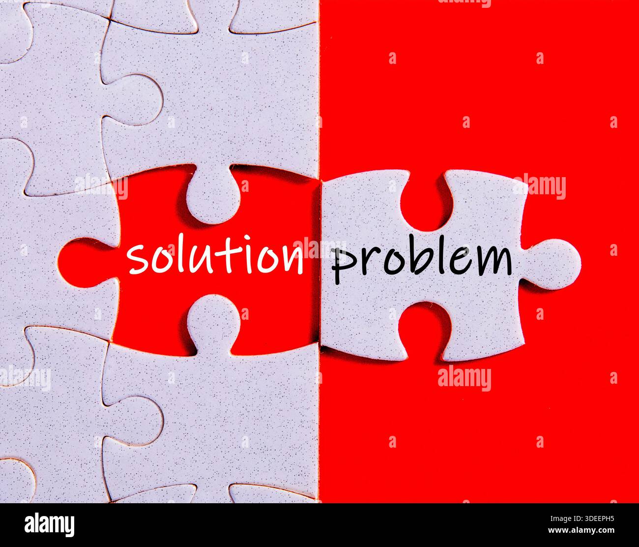 Jigsaw puzzle showing a white piece with word problem and missing piece revealing solution Stock Photo