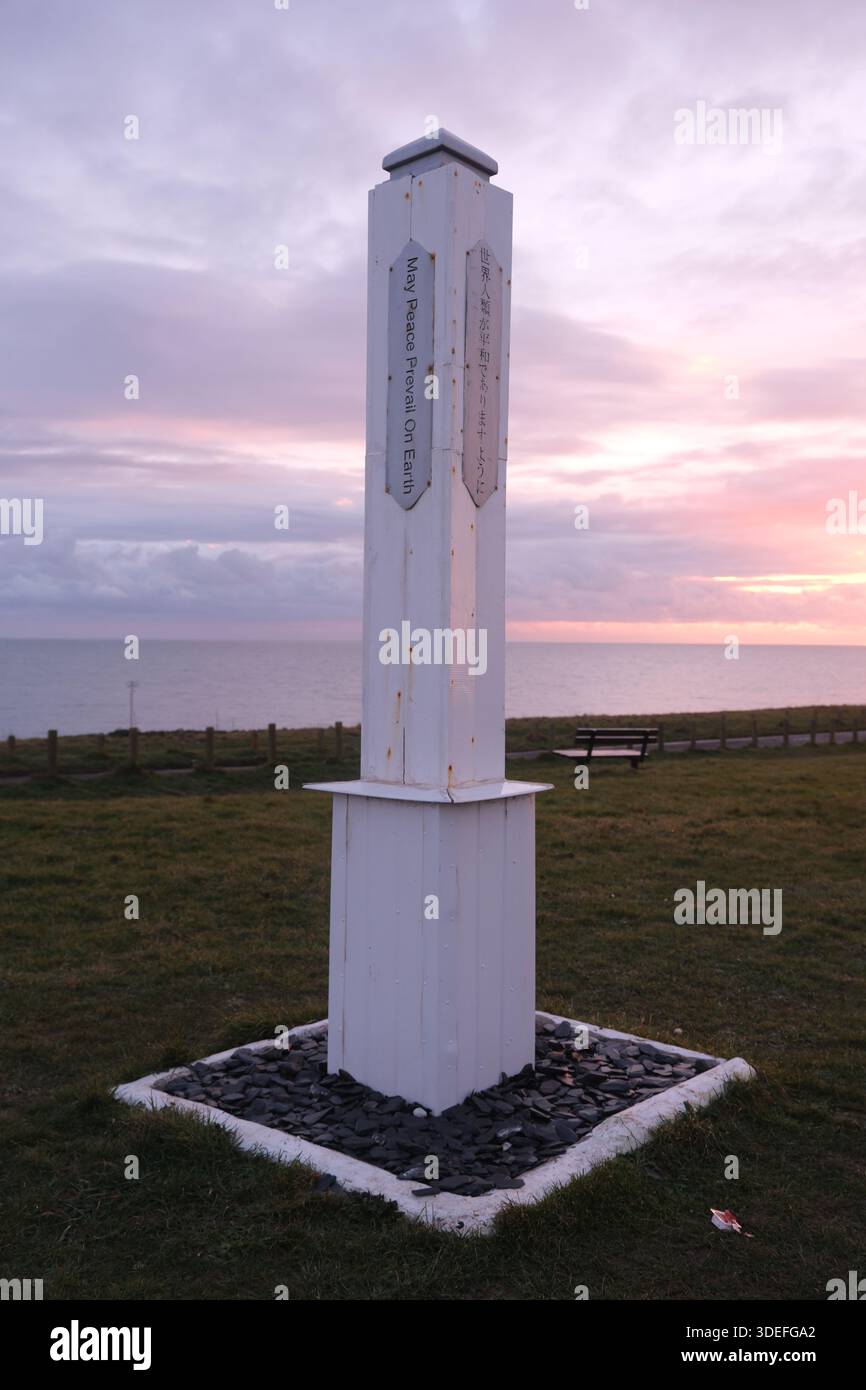 Wooden Peace Pole near the top of Galley Hill - inscribed with "May Peace Prevail on Earth" in multiple languages - Bexhill-on-Sea East Sussex England Stock Photo