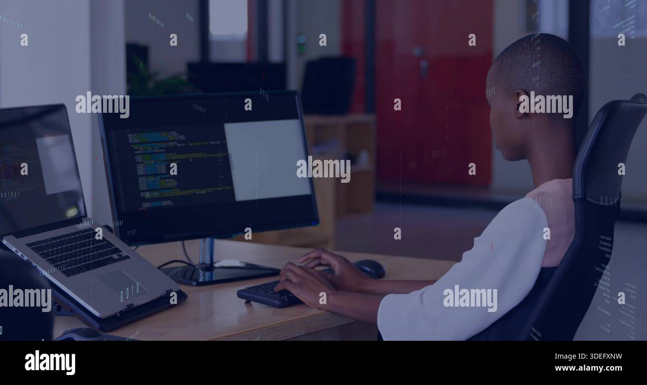 Typing man wearing light top using screen with code and laptop in modern office, copy space Stock Photo