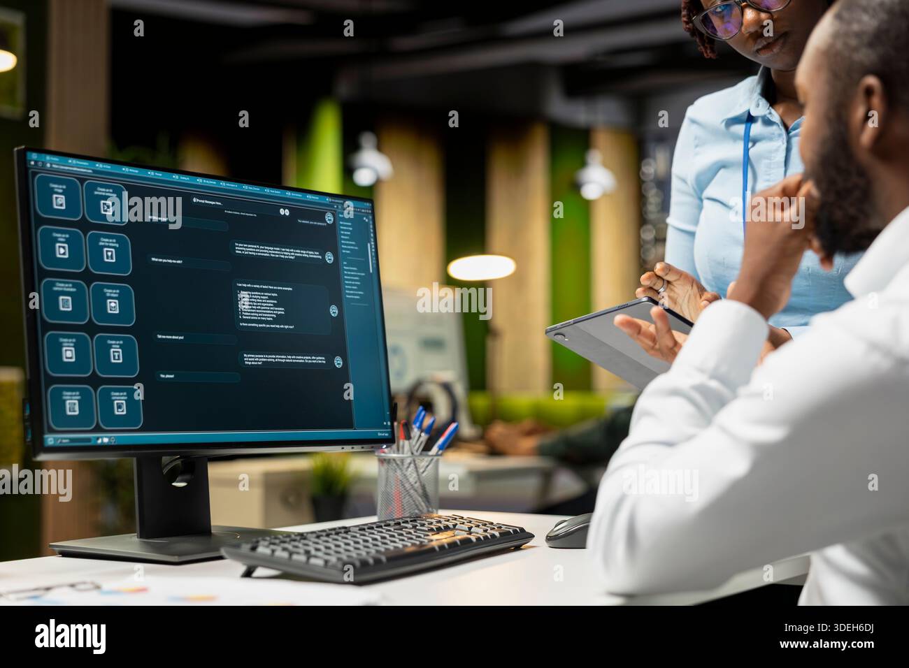 Black IT engineers team developing app and software algorithm on pc, working in the office late at night. Specialists use digital tools and focuses on script engineering and coding. Stock Photo