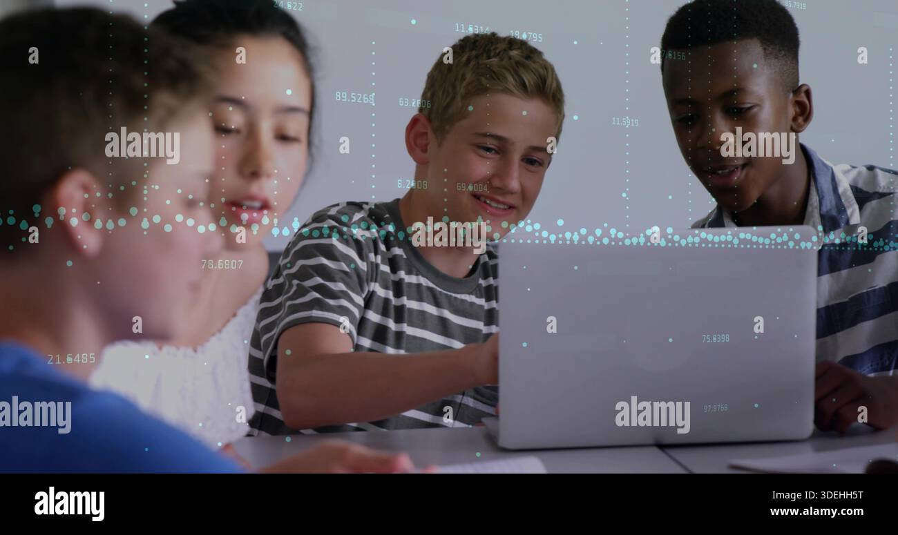 Collaborating students in striped shirts typing notes at study table with laptop and data overlays Stock Photo