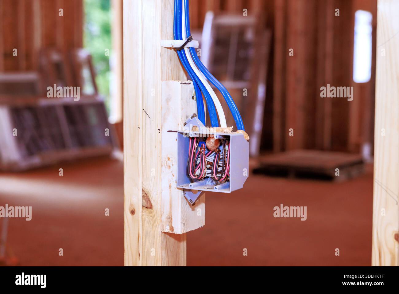 Workers install an electric box to power switch inside building that is ...