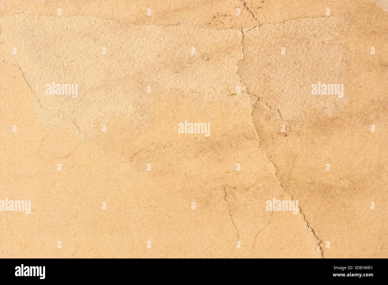 old vintage paper on full frame surface, weathered grainy texture with warm beige matte finish and visible fibers copy space historical background Stock Photo