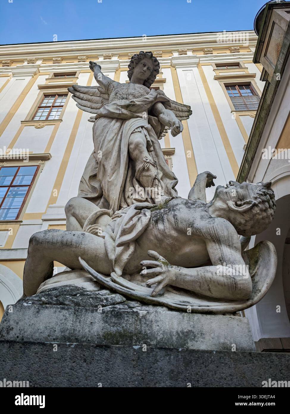 Baroque stone sculpture of Archangel Michael defeating a demon in a ...
