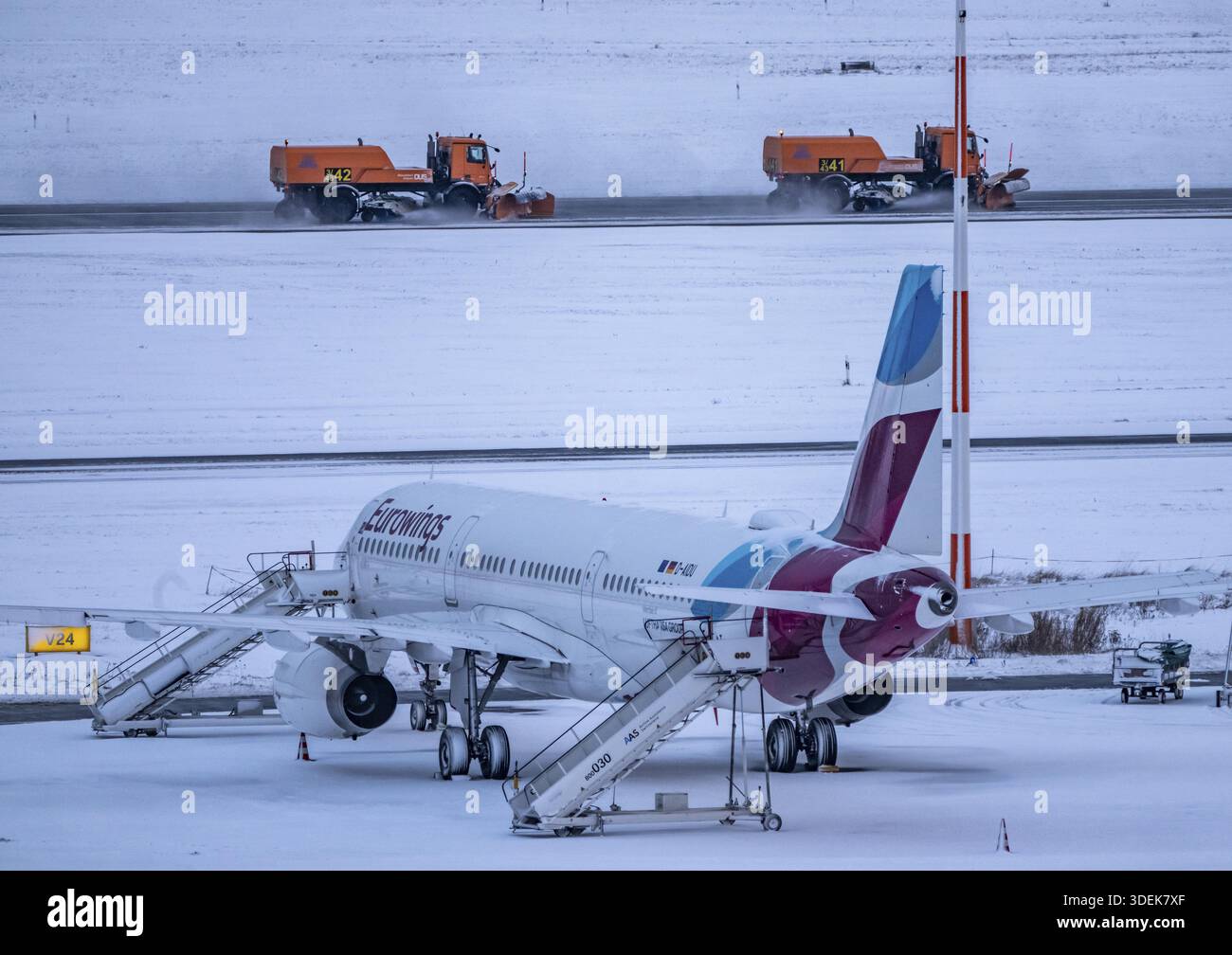 The onset of winter in North Rhine-Westphalia, flight operations are maintained at Duesseldorf airport with great effort, taxiways, runway are freed f Stock Photo