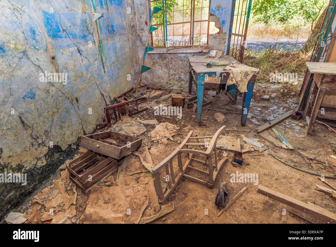 An abandoned living room left behind after a devastating earthquake in the 1960s. The former residents fled, leaving furniture and personal belongings Stock Photo