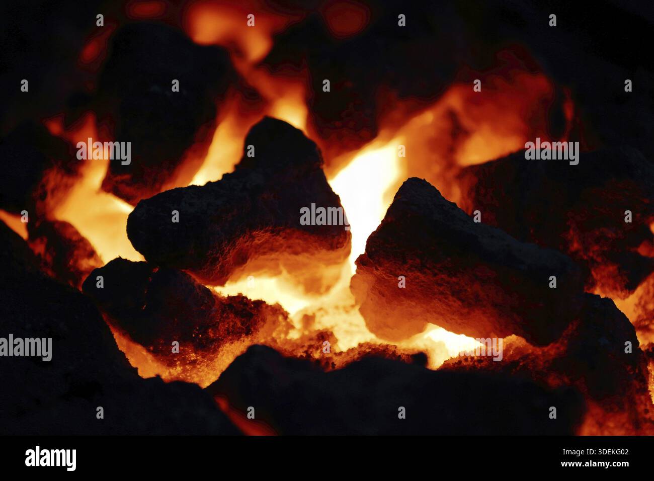 Textured smoldering charcoal surface in a fireplace Stock Photo