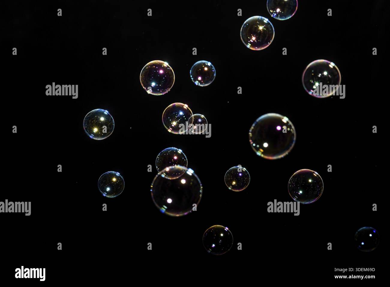 Beautiful multicolored soap bubbles on black background for texture and background Stock Photo