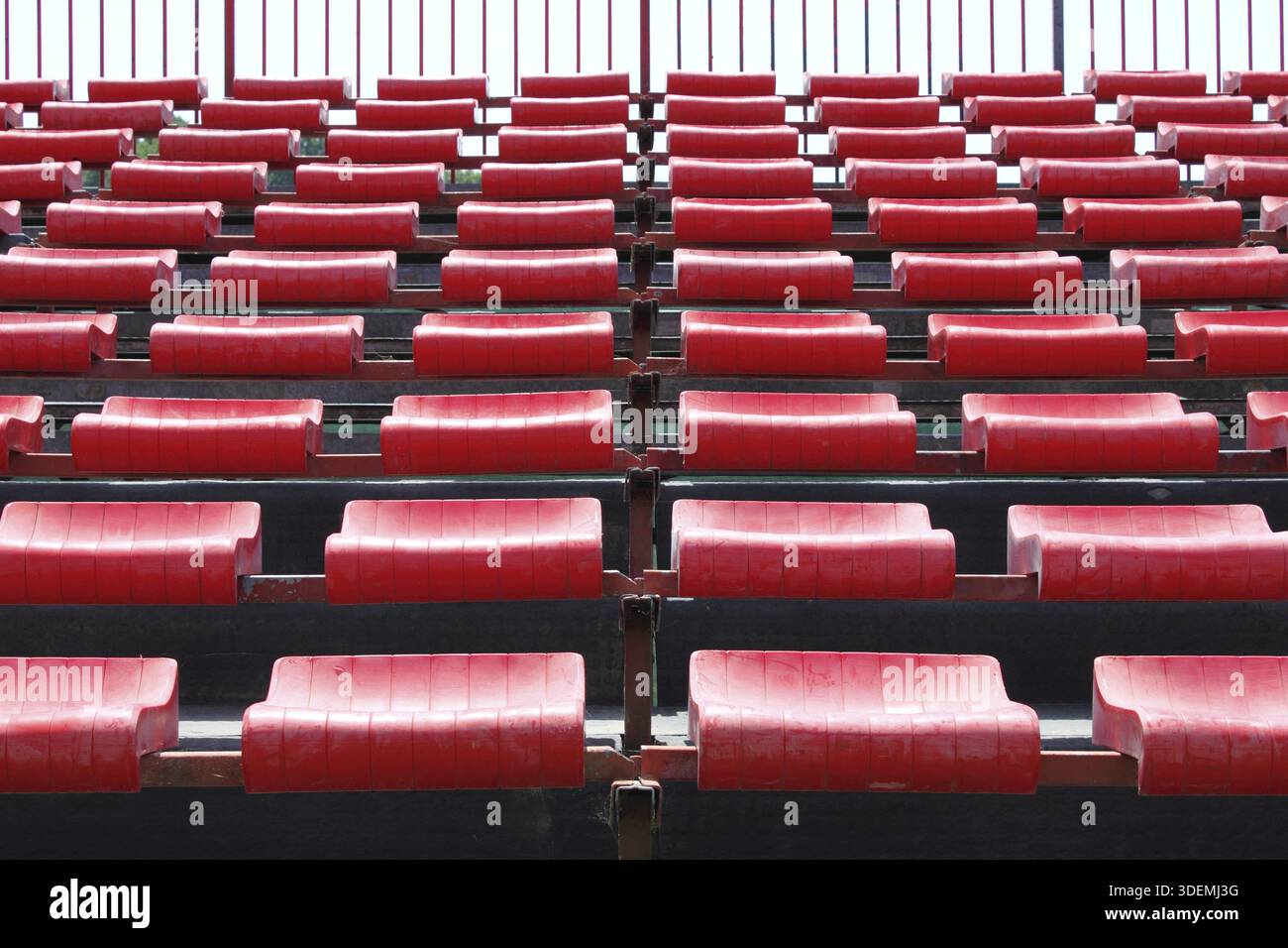 Empty and numbered seats in a stadium Stock Photo