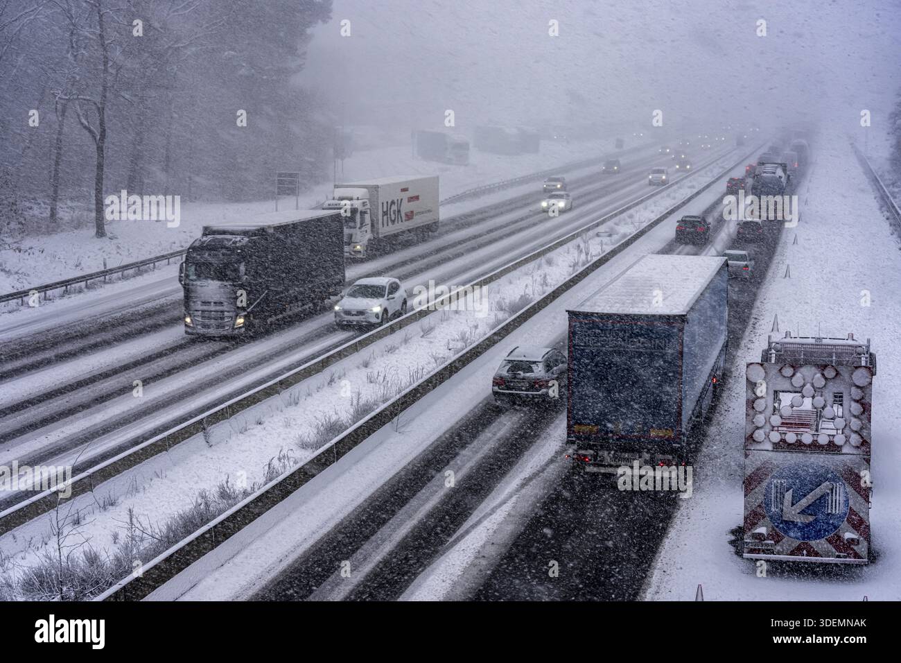 The onset of winter in North Rhine-Westphalia, heavy snowfall, A3 motorway near Hilden, near Ohligser Heide rest area, snow-covered roads, traffic is Stock Photo