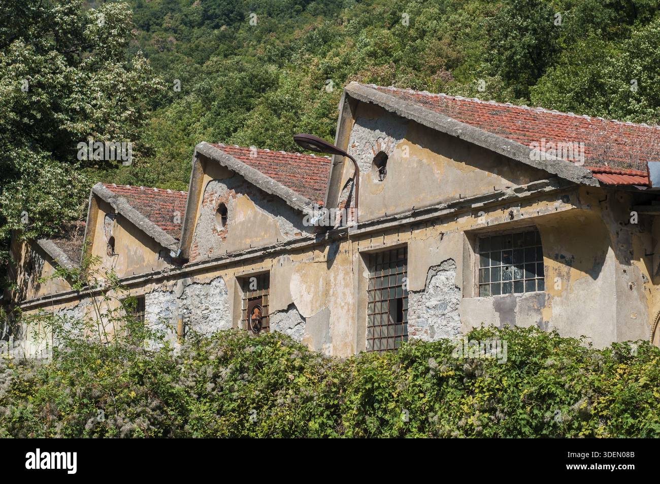 Old obsolete industrial building facade with broken windows Stock Photo