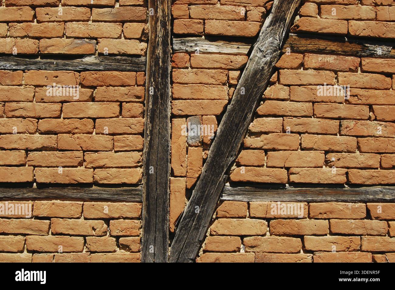 Old frame-build half-timbered red bricks barn's wall horizontal Stock Photo