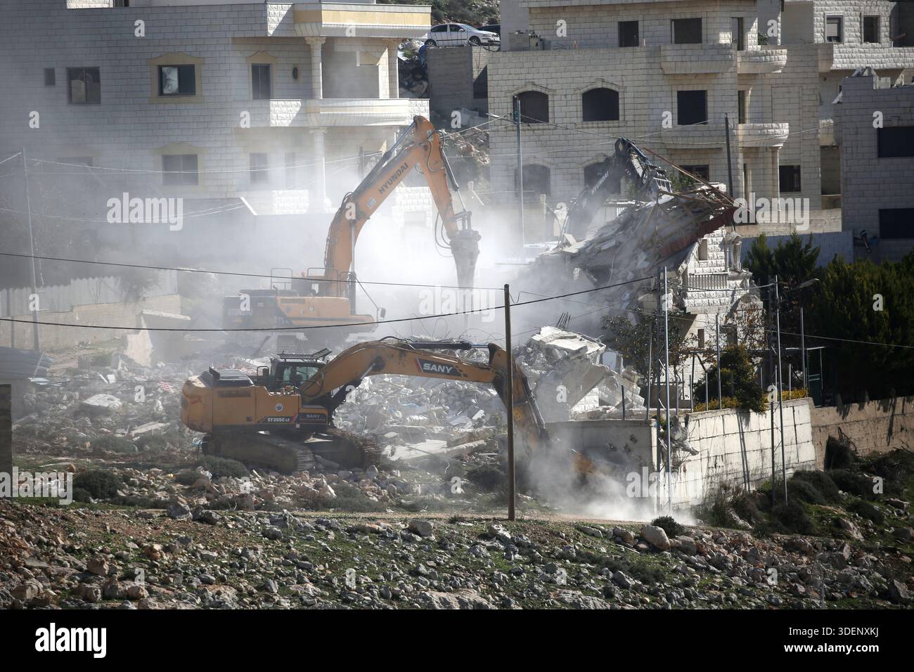 Israeli military bulldozers demolish a house in the Al-Ta'awun ...