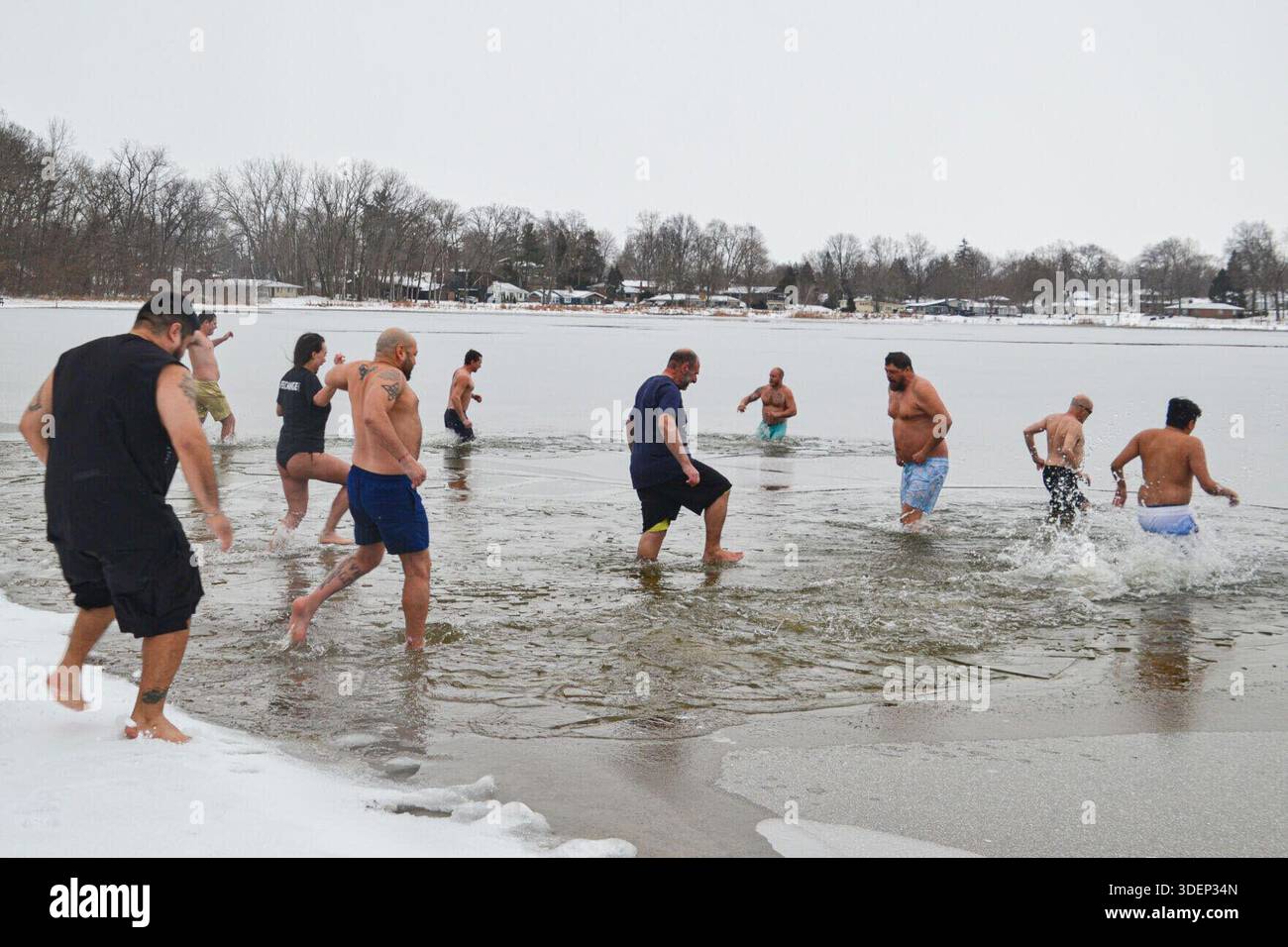 New Year's Day Polar Plunge participants make their way into Stone Lake ...