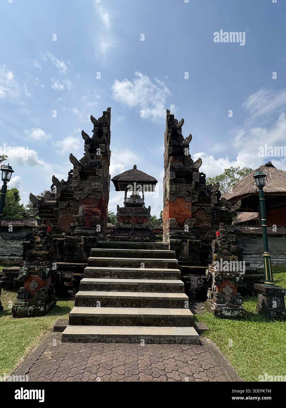 Traditional Balinese temple entrance with intricately carved stone gateway and cultural architectural details in Bali, Indonesia - Smartphone Captured Stock Image