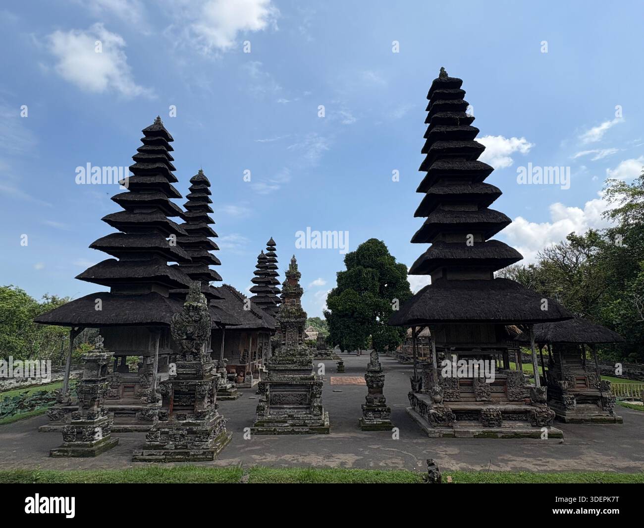 Traditional Balinese temple entrance with intricately carved stone gateway and cultural architectural details in Bali, Indonesia - Smartphone Captured Stock Image