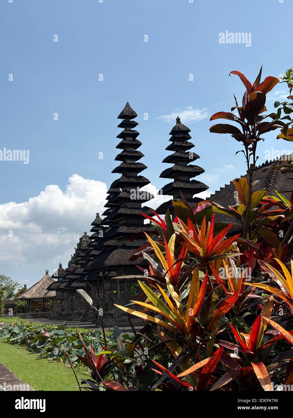 Traditional Balinese temple entrance with intricately carved stone gateway and cultural architectural details in Bali, Indonesia - Smartphone Captured Stock Image