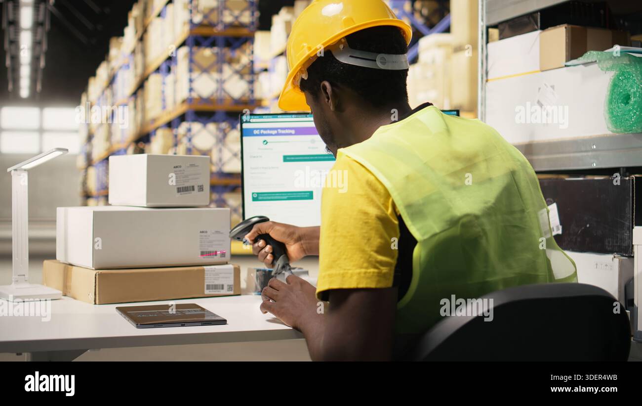 Storage room employee scanning shipping labels to register in inventory ...