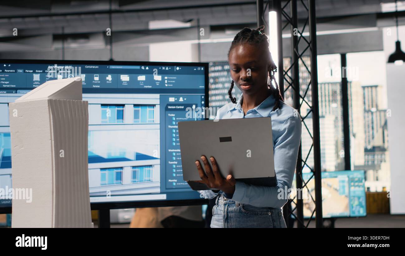 African american male developer examines detailed construction ...