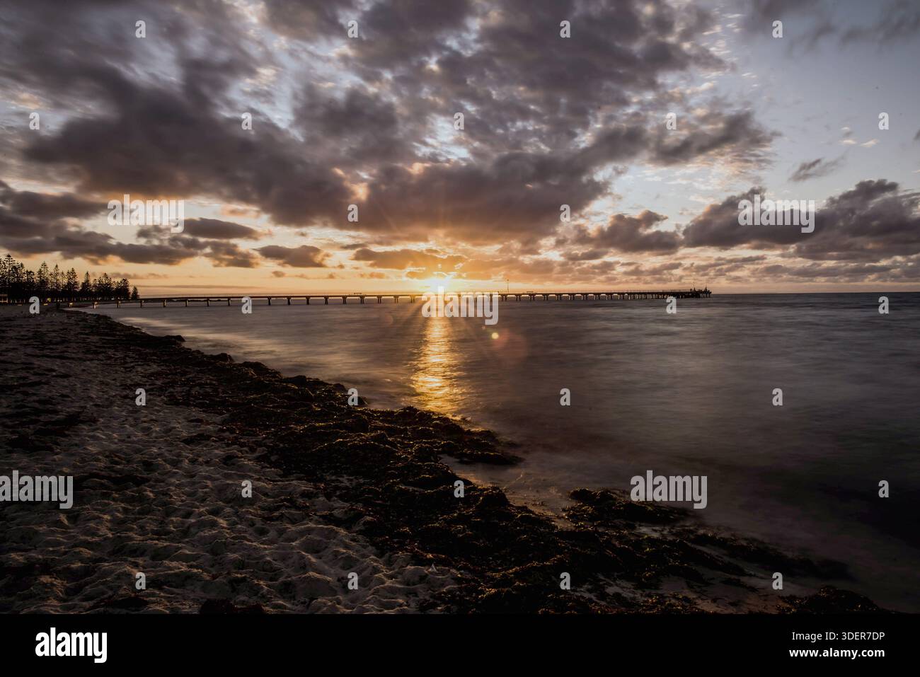 An attractive beautiful view of the sun rising at Altona Beach Pier in ...