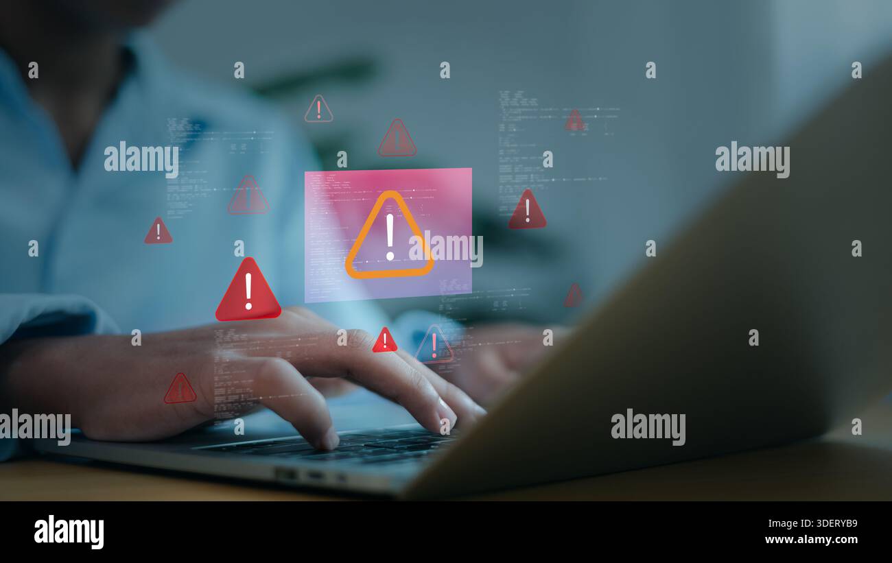 Man hands using laptop with digital red warning icons, system error, virus attack and cybersecurity concept. Professional programmer troubleshooting s Stock Photo
