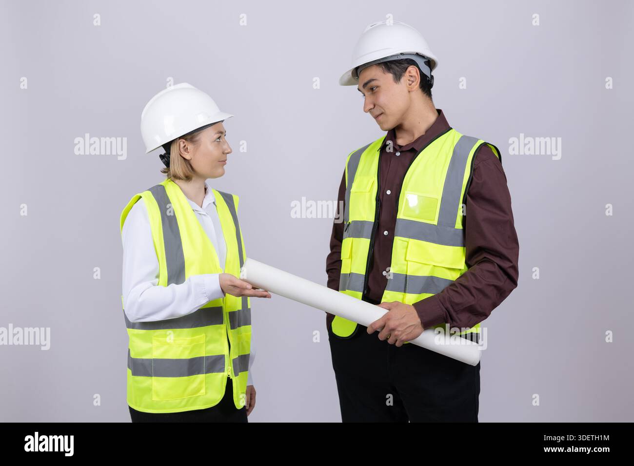 Male and female engineers discussing plan Stock Photo
