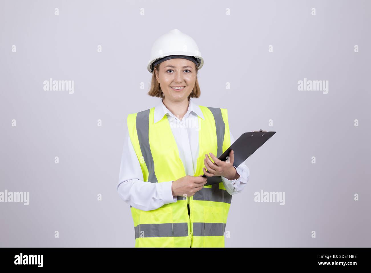 Female engineer in hardhat using digital tablet Stock Photo