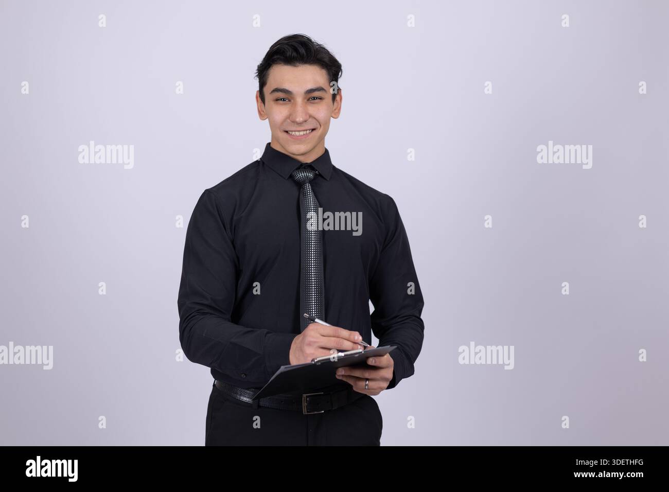 Young man in black shirt using tablet Stock Photo