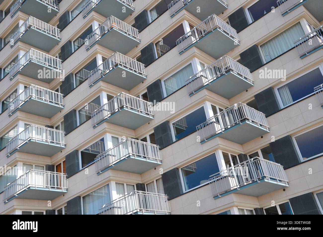 High-rise facade with many balconies across corners Stock Photo - Alamy