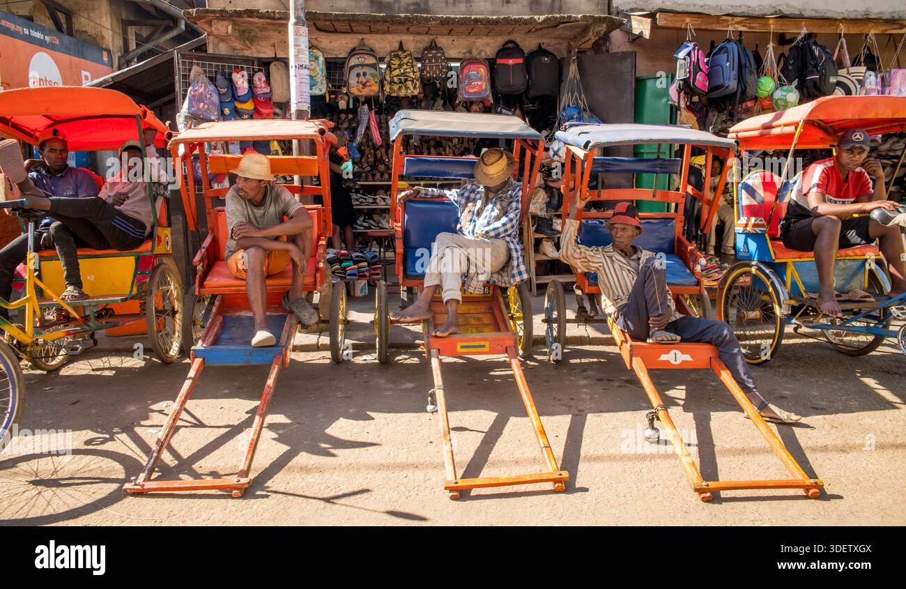 Rickshaw pullers in Antsirabe with their brightly decorated pousse ...