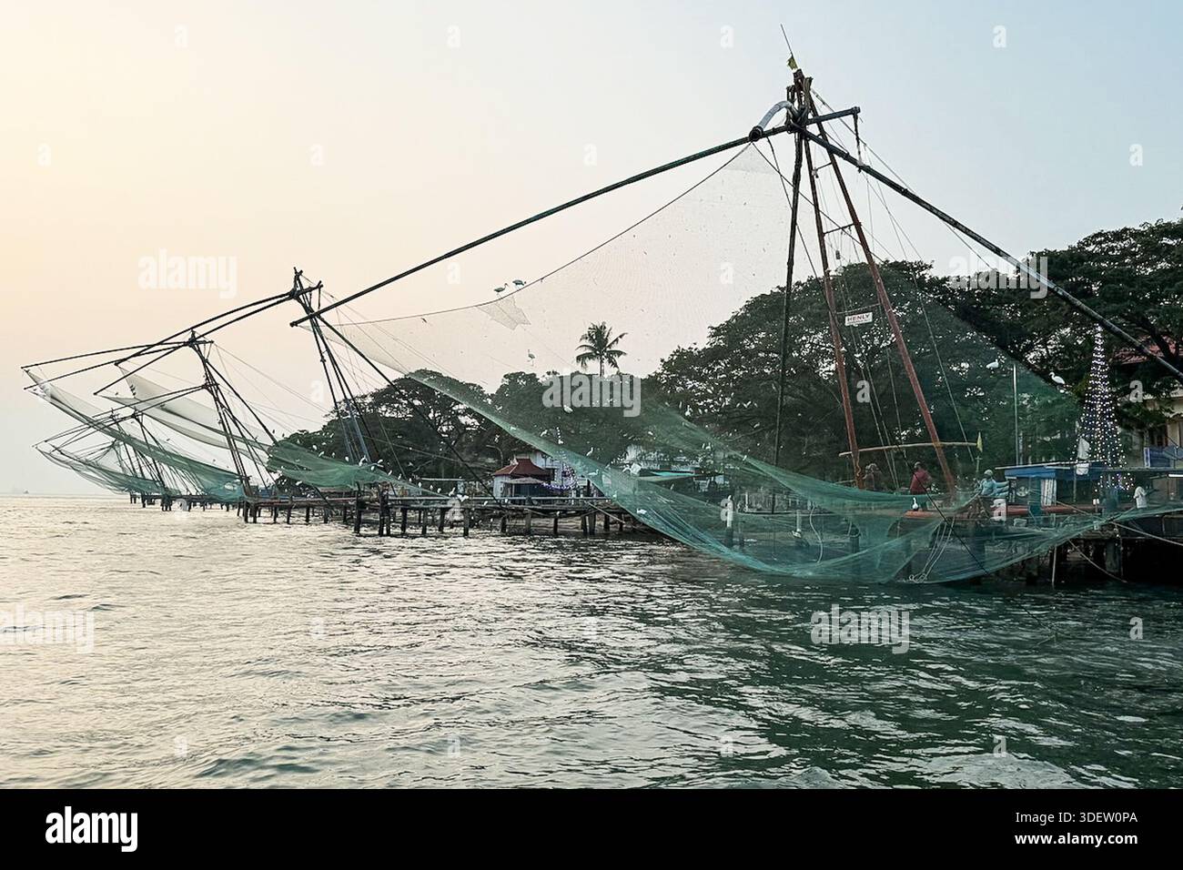 Traditional Chinese fishing nets line the waterfront in Kochi, Kerala ...